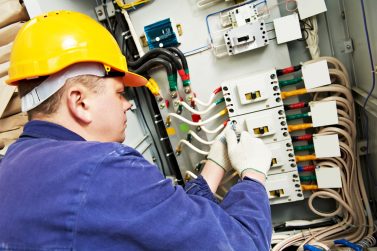 39028413 - electrician builder at work with tester measuring high voltage and current of power electric line in electical distribution fuseboard